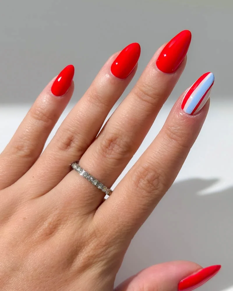 4th of july nails 2026 + Minimalist Red Almond Nails with a Crisp Striped Accent