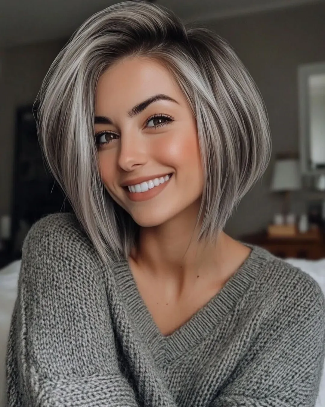 angled summer haircut for round face 2026 + Smoky Silver Graduated Bob With a Sleek Forward Angle