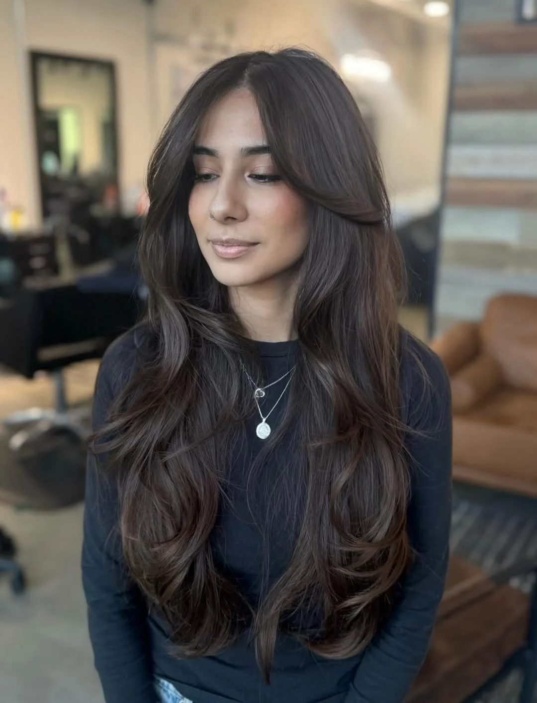 angled summer haircut for round face 2026 + Glossy Espresso Layers With Feathered Curtain Framing