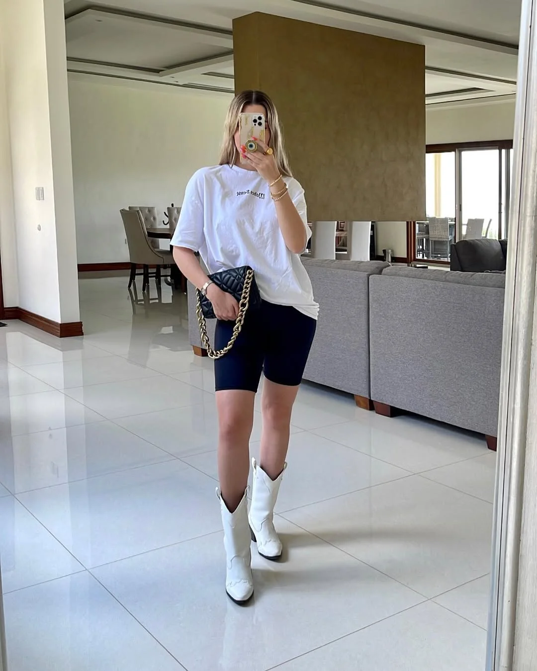 biker shorts outfits summer 2026 Oversized White Tee With Black Biker Shorts And Western Boots