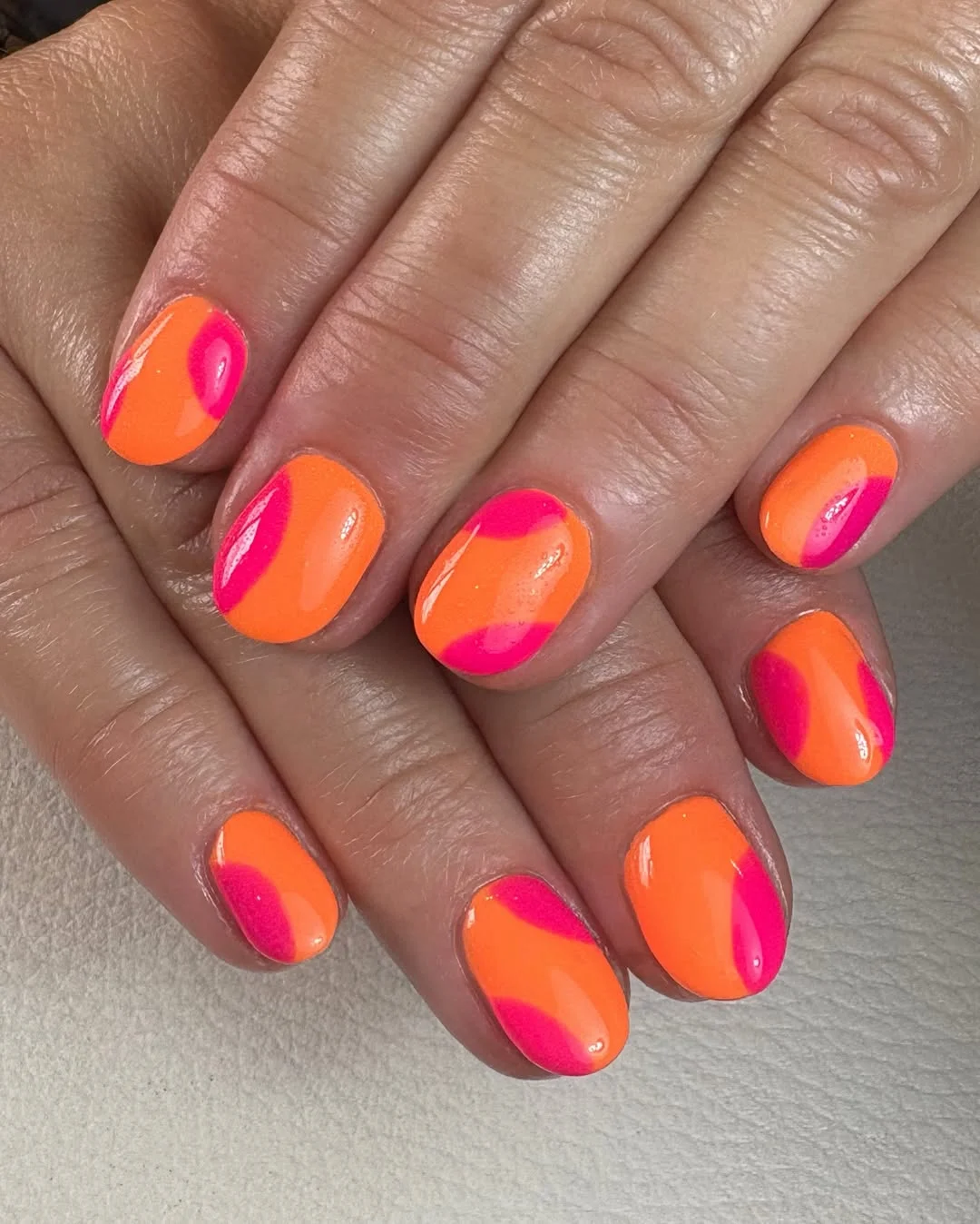 bright summer nails 2026 + Neon Orange Waves With Pink Accent Curves