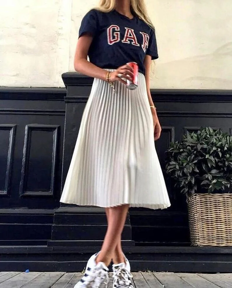 casual friday summer outfits with sneakers 2026 Graphic Tee And Pleated Skirt With Clean Sneaker Energy