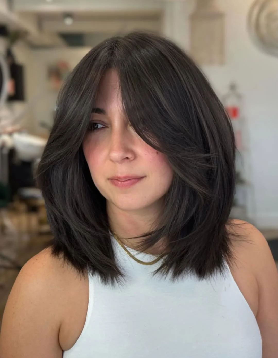 layered summer bob haircut 2026 Full Curtain Bangs With A Medium Layered Bob Shape