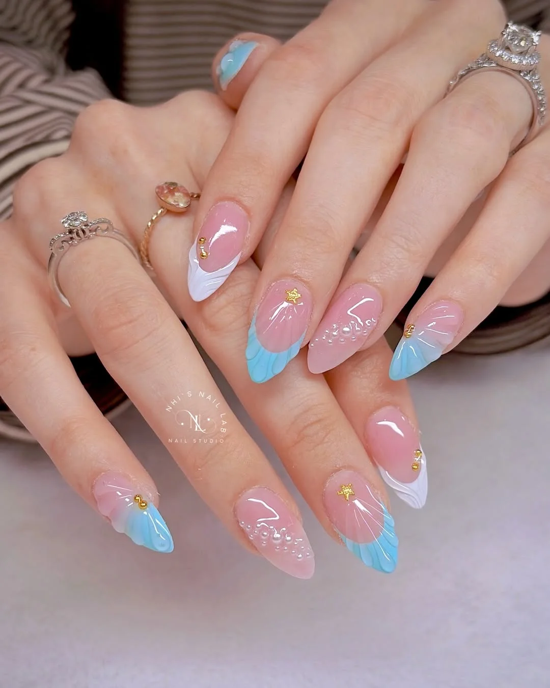 light summer nails 2026 + Pastel Seashell Tips with Golden Starfish Details