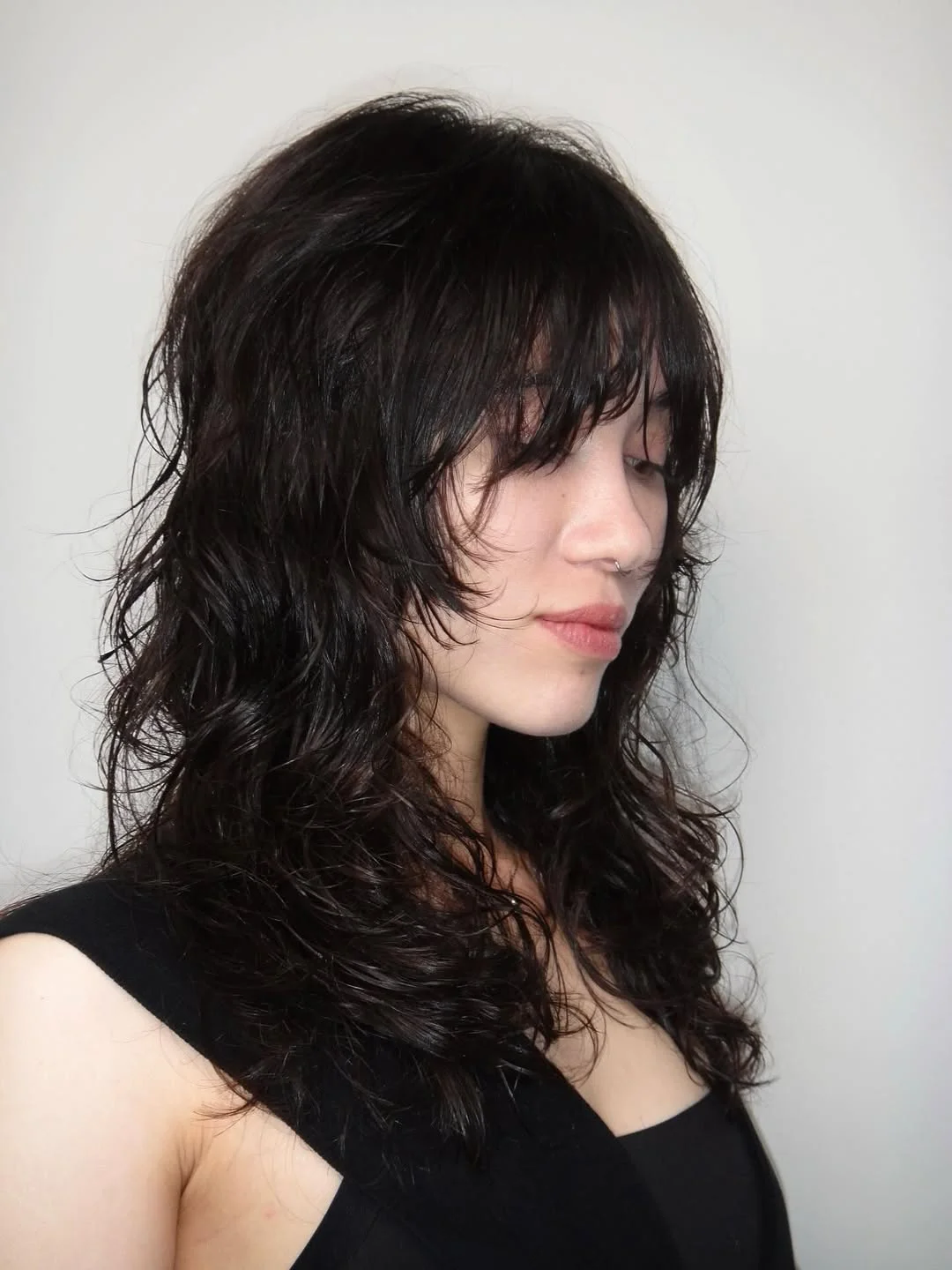 messy summer shag haircut 2026 Side-Swept Black Shag With Wet-Look Texture