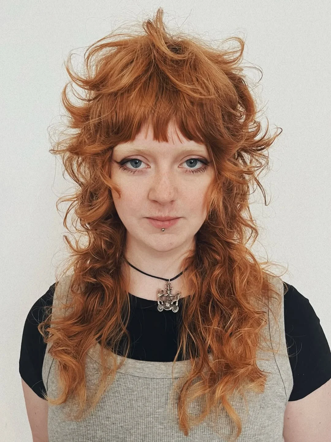 messy summer shag haircut 2026 Copper Curly Shag With Baby Bangs
