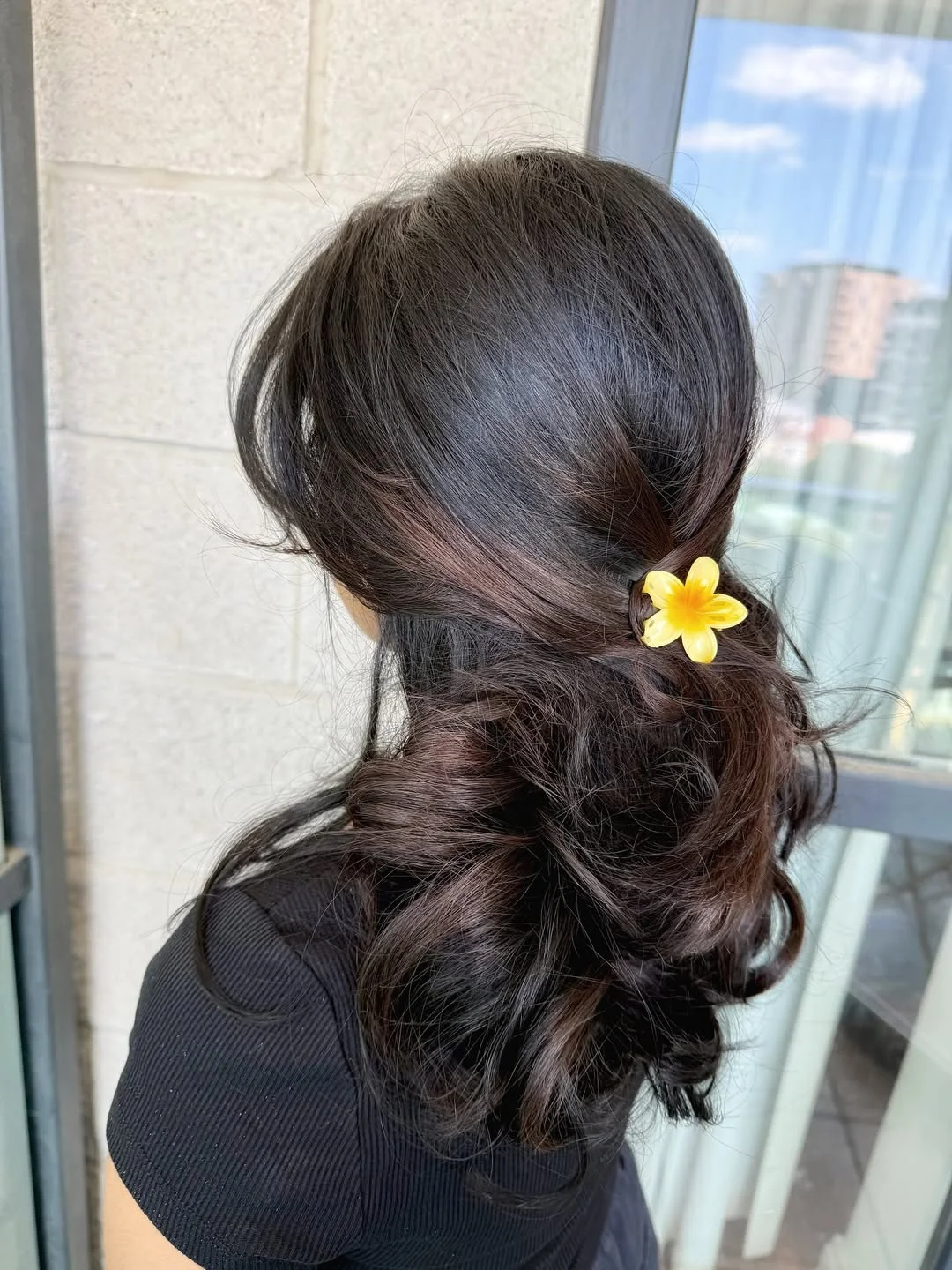 modern summer haircut 2026 Romantic Low Ponytail With A Yellow Flower Clip