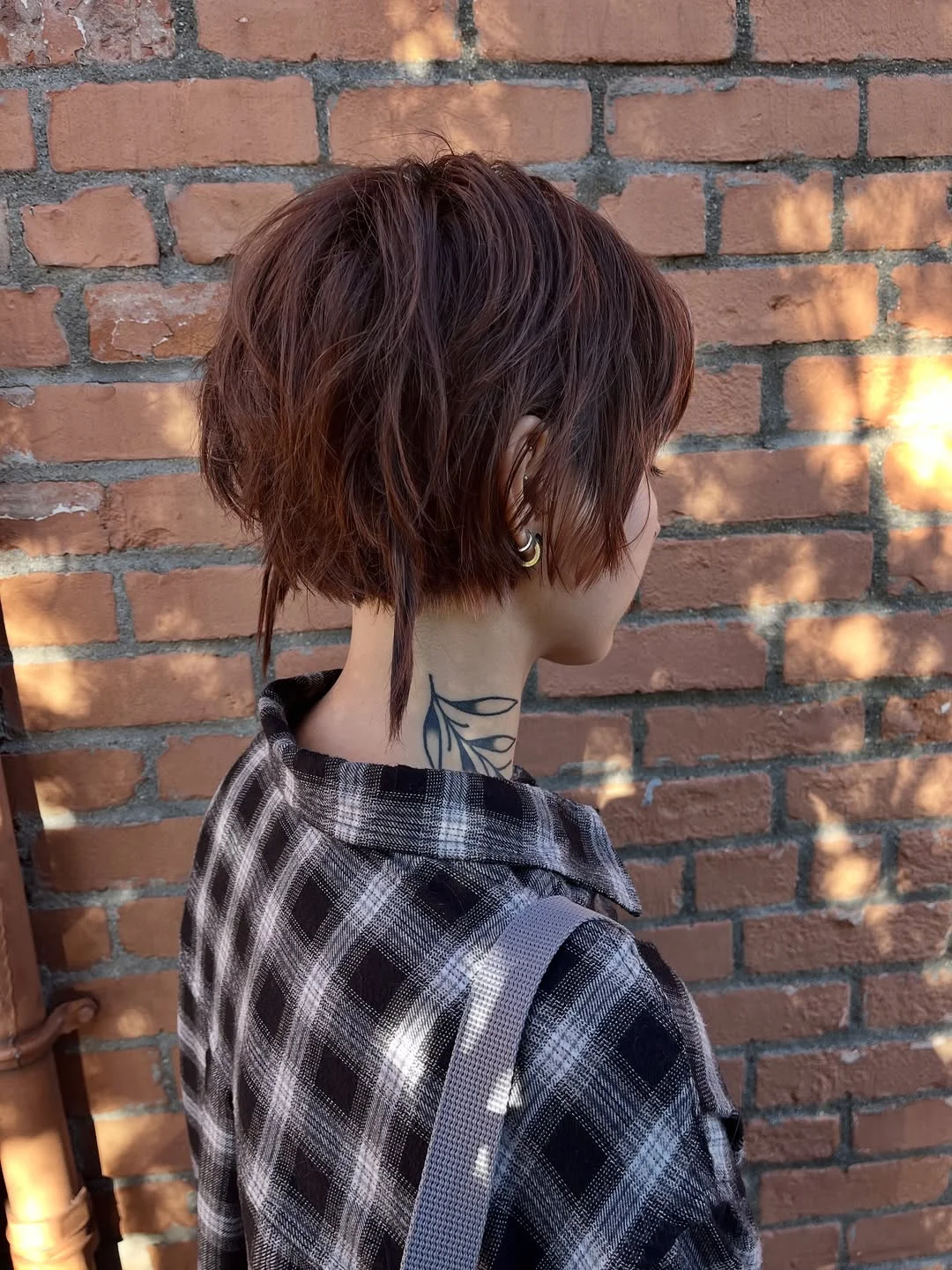 modern summer haircut 2026 Textured Auburn Pixie Mullet With A Nape Tail