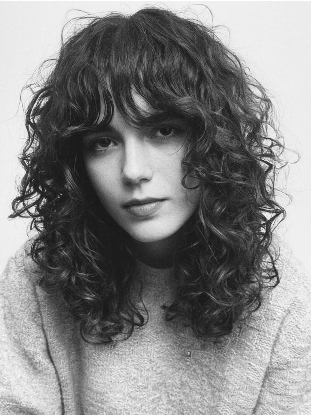 modern summer haircut 2026 Long Curly Shag With Full Fringe