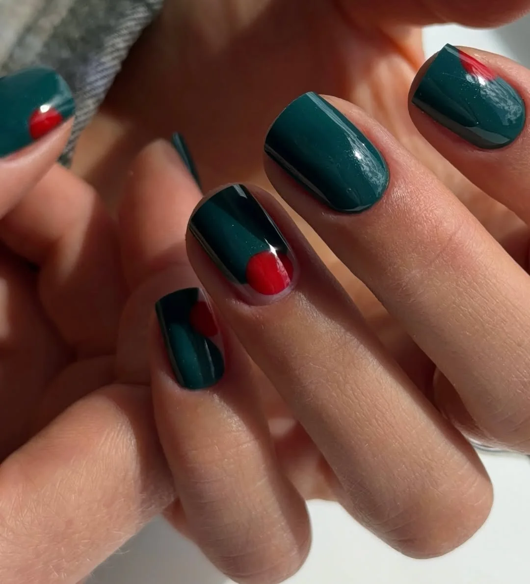 short squoval nails design 2026 + Deep Green Squoval Nails with Red Half Moon Accents