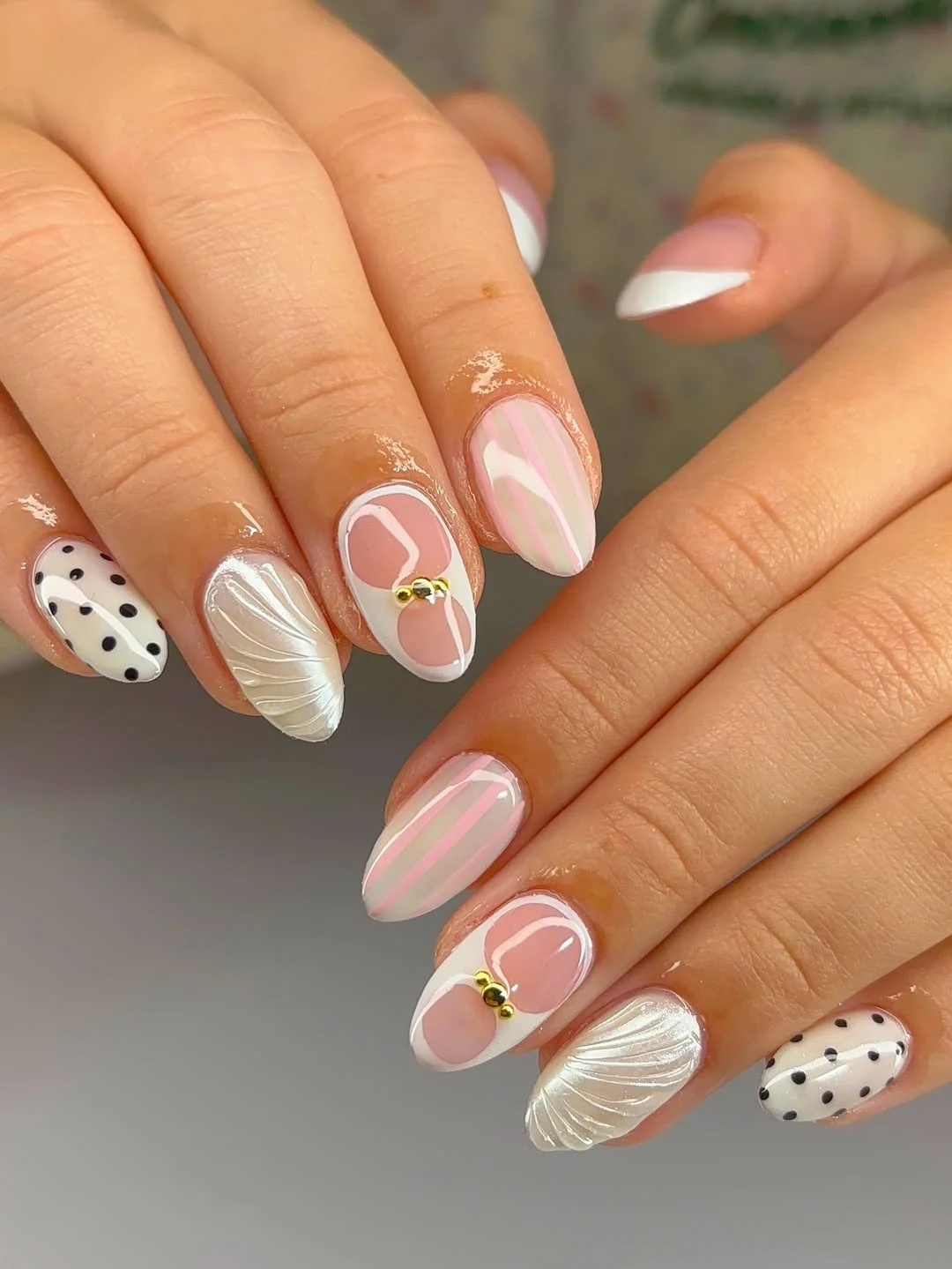 short squoval nails design 2026 + Pearl Shell Texture and Pink Graphic Details