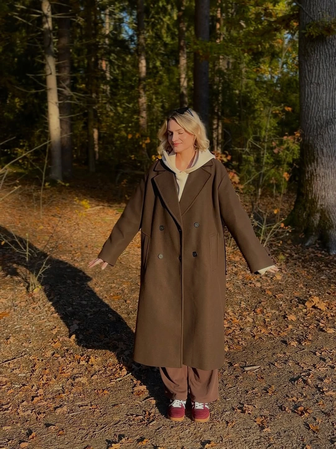 comfy fall outfits 2026 A Long Brown Coat Over a Hoodie Is My Fall Shortcut