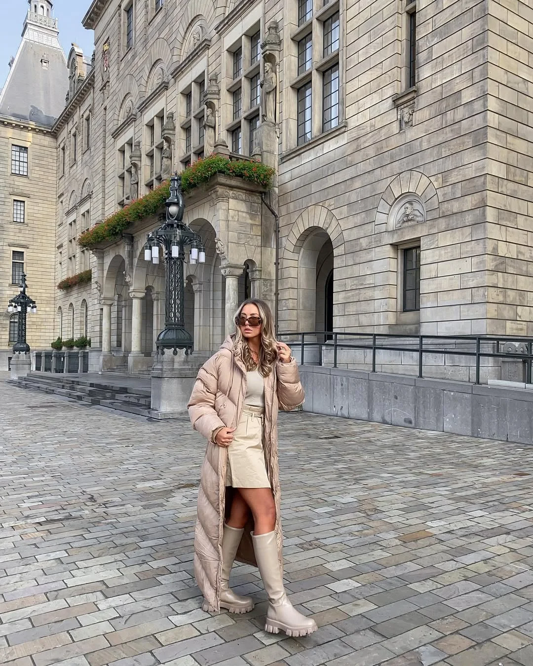 fall fashion outfits 2026 Monochrome Puffer Coat With a Mini Skirt and Tall Boots
