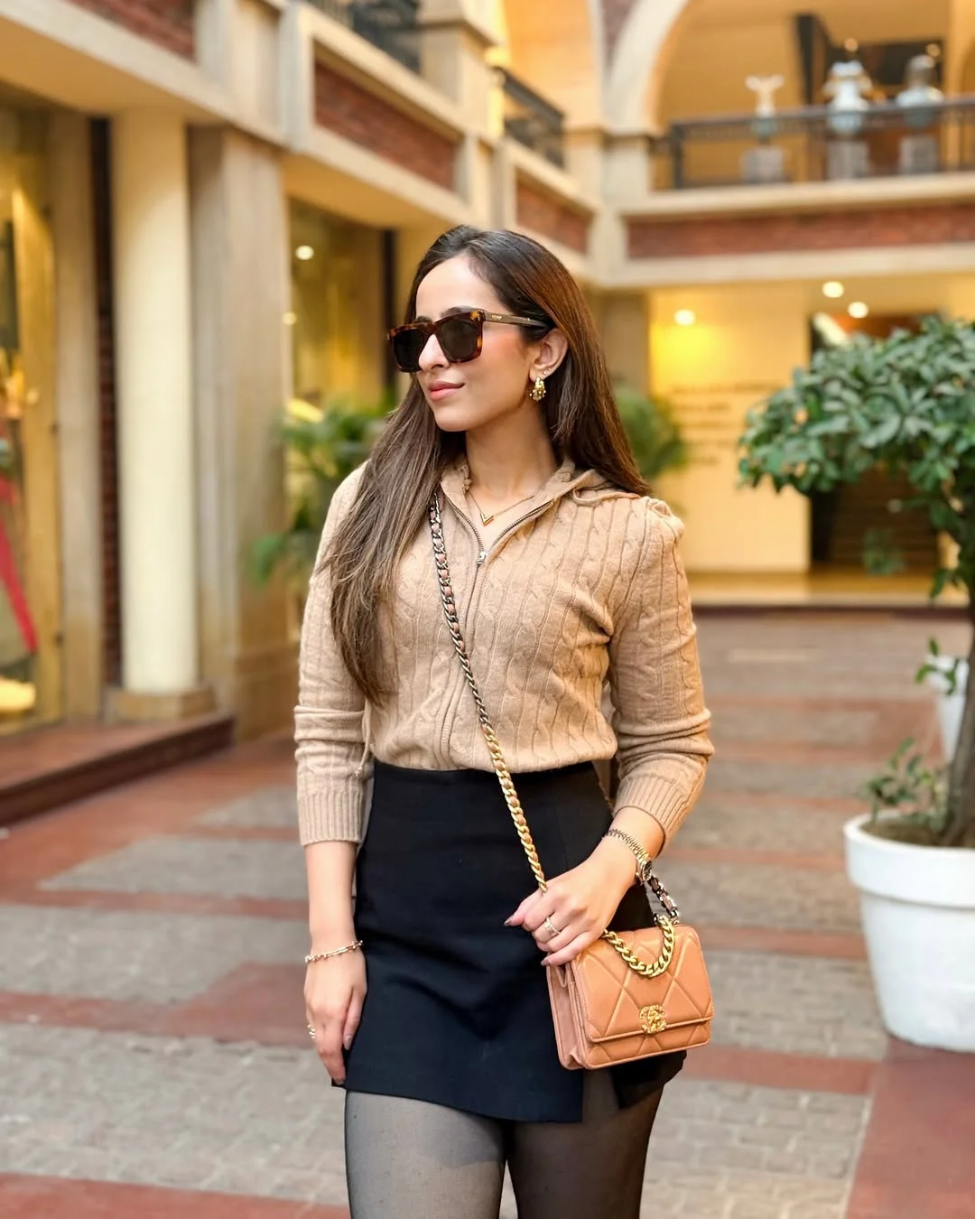 fall fashion outfits 2026 Cable-Knit Zip Sweater With a Black Mini Skirt