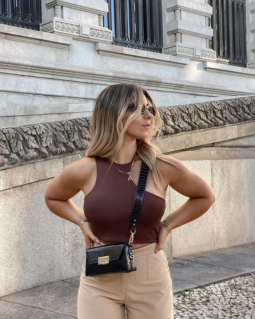 Early summer outfits 2026 Brown One-Shoulder Knit With Soft Beige Trousers
