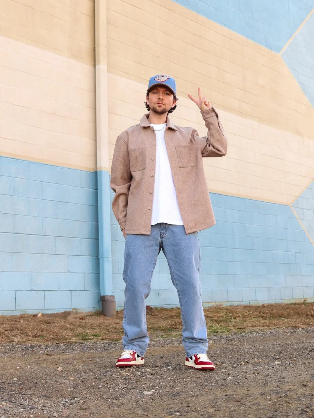 Fall outfits ideas for men 2026 Soft Neutrals With Red Sneaker Energy