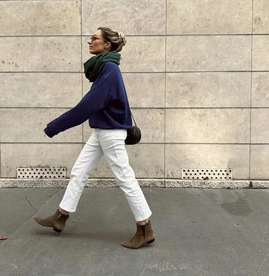 fall outfits with jeans 2026 + Navy Sweatshirt, White Jeans, And Olive Ankle Boots