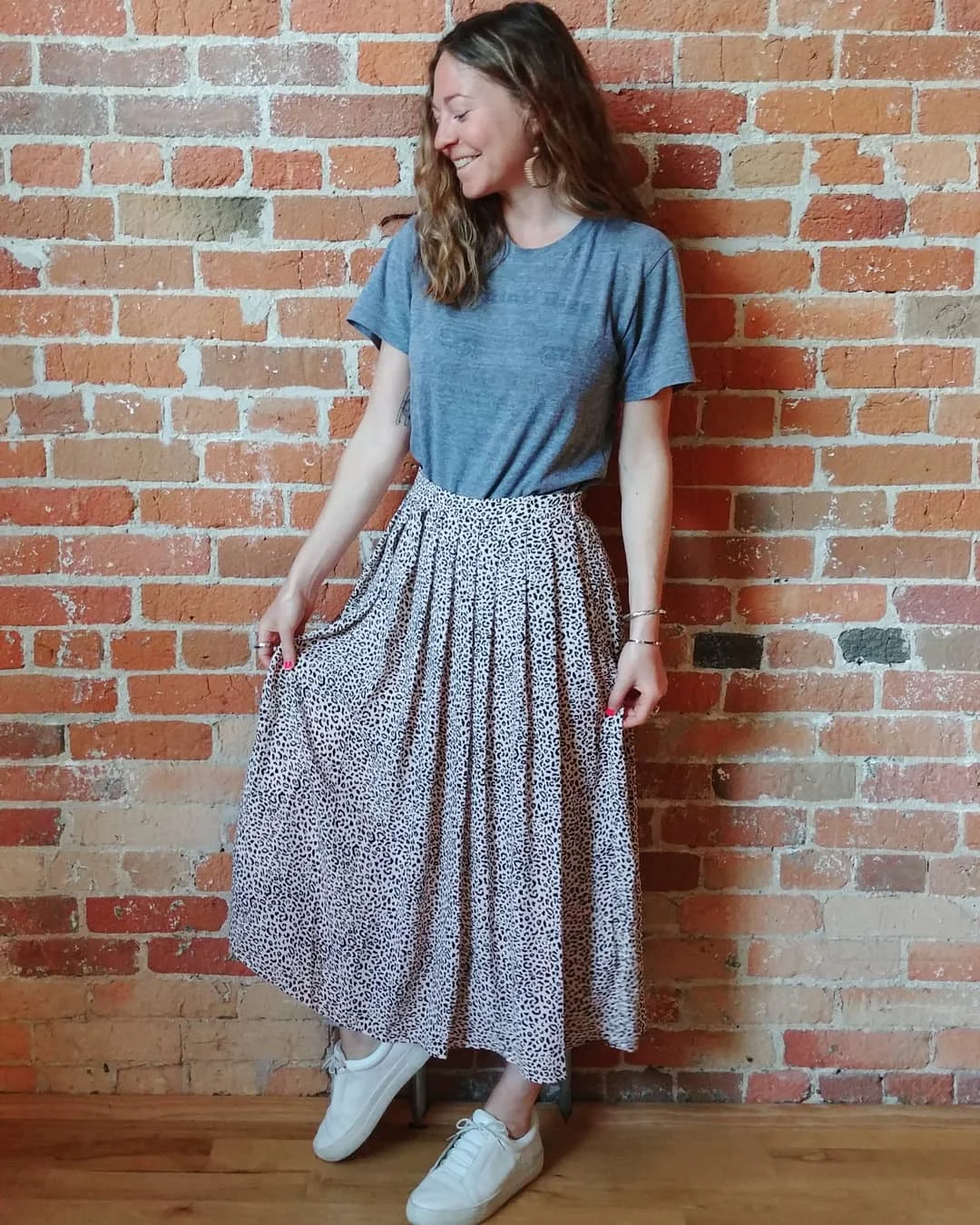 fall skirt and sneakers outfits 2026 + Gray Tee With A Spotted Pleated Midi And White Sneakers