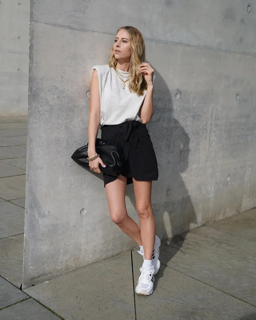 fall skirt and sneakers outfits 2026 + Black Mini Skort With Chunky Sneakers And Gold Jewelry