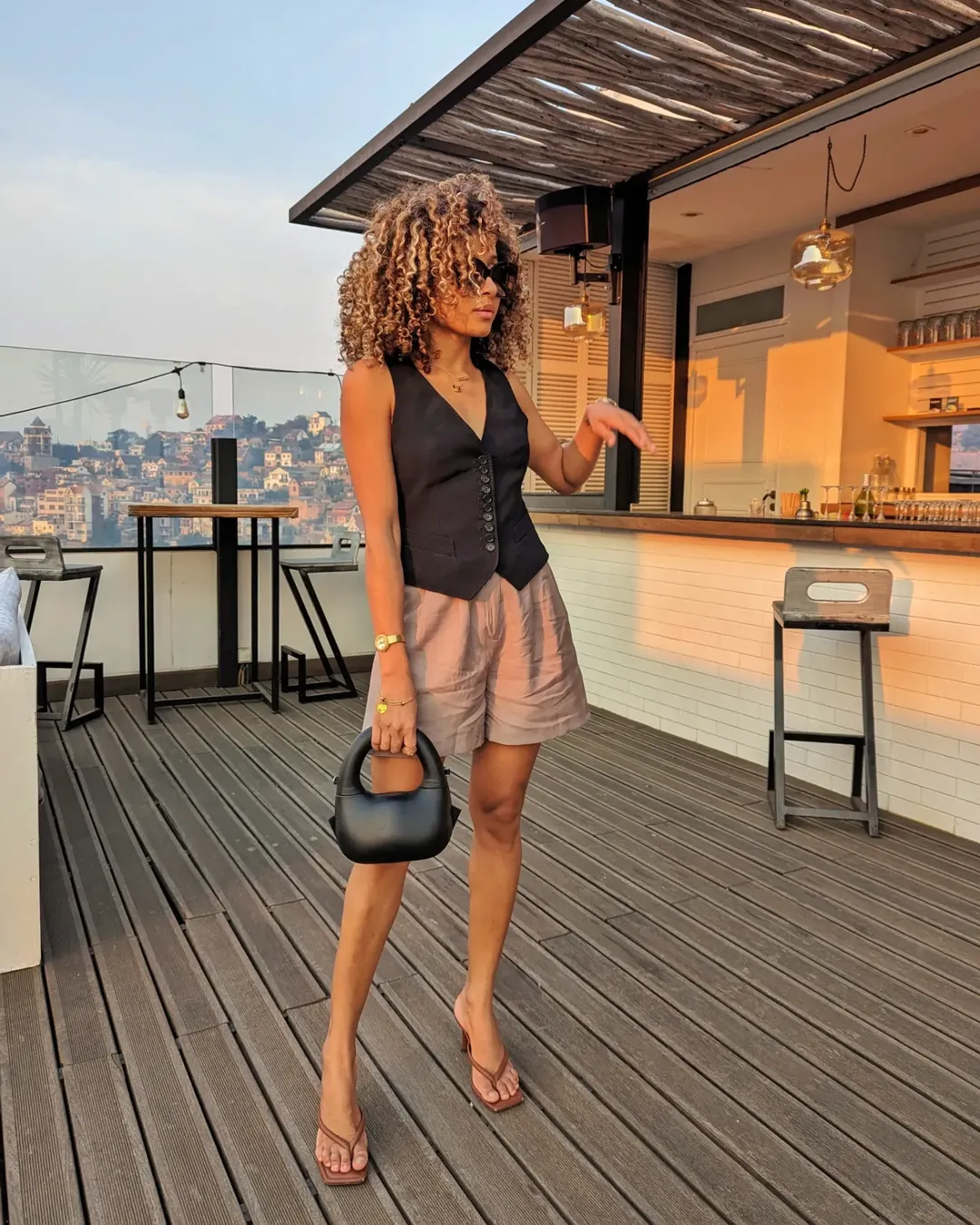 fall vest outfits for women 2026 Black Vest and Brown Shorts for Sunset Drinks