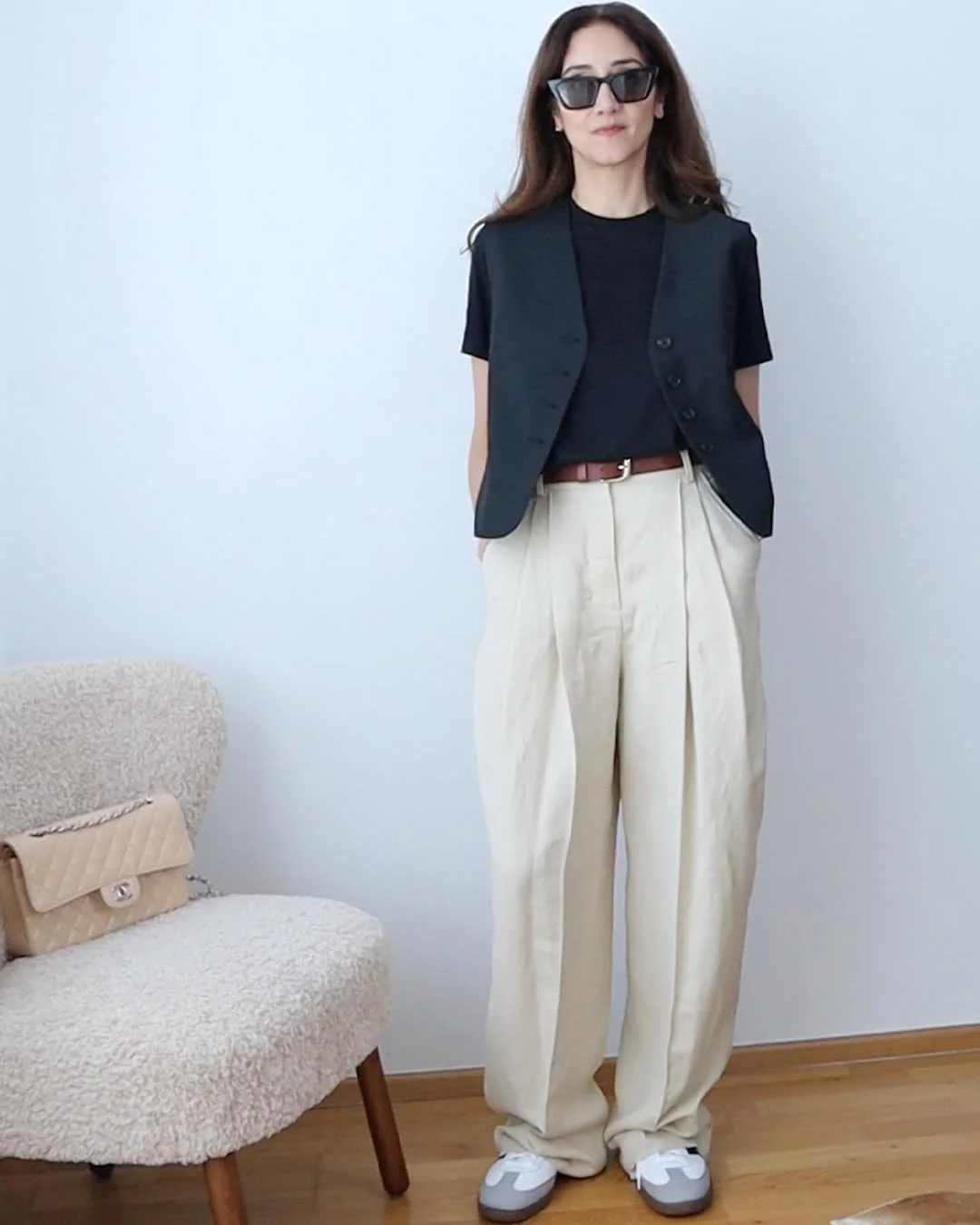 fall vest outfits for women 2026 Black Vest Over a Tee With Relaxed Cream Trousers