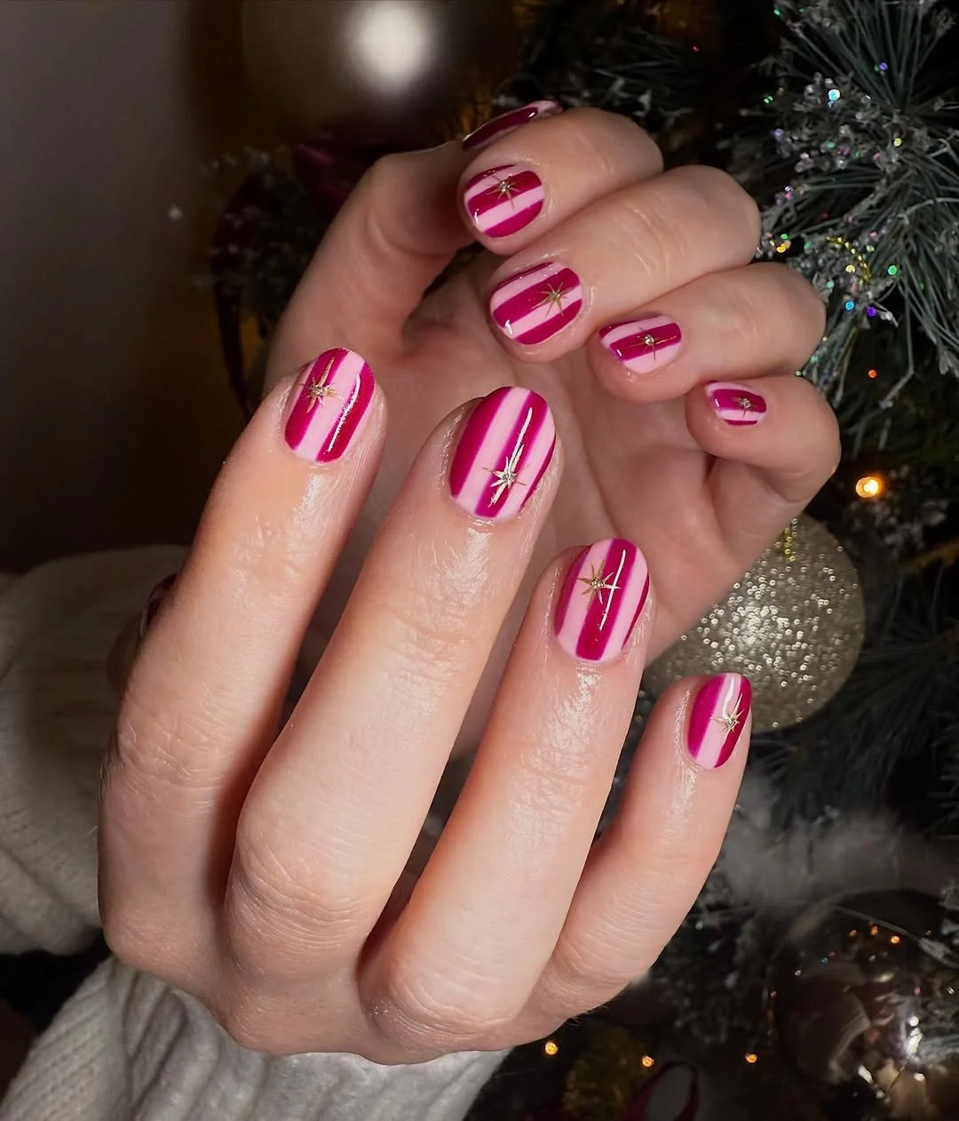 July nail colours ideas 2026 Berry Pink Stripes With Tiny Gold Starbursts