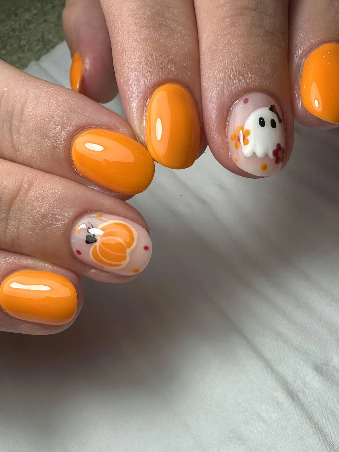 July nail colours ideas 2026 Glossy Orange Short Nails With Playful Accent Art