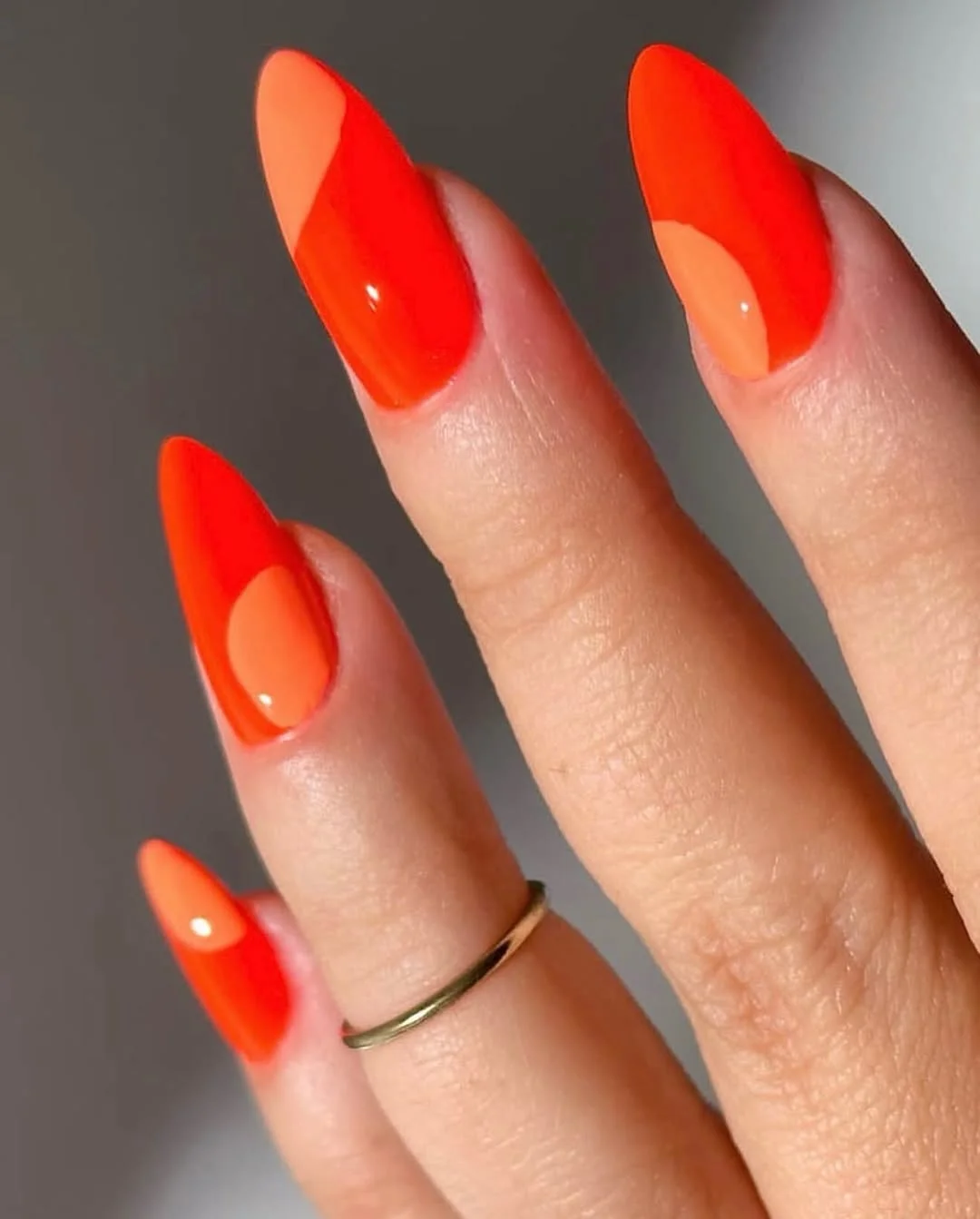 July nail colours ideas 2026 Tangerine Red Almond Nails With Soft Peach Curves
