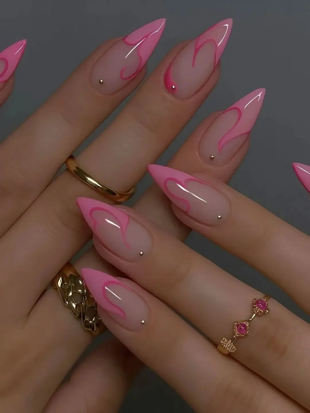july nails design ideas 2026 + Pink Heart-Tip Stiletto Nails With Tiny Gold Studs