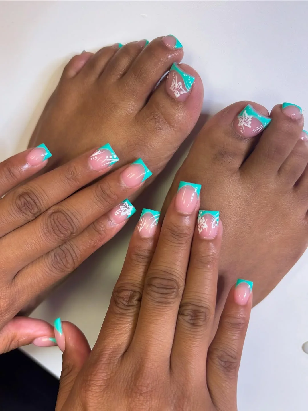 July toe nail colours ideas 2026 Aqua French Tips With White Summer Florals
