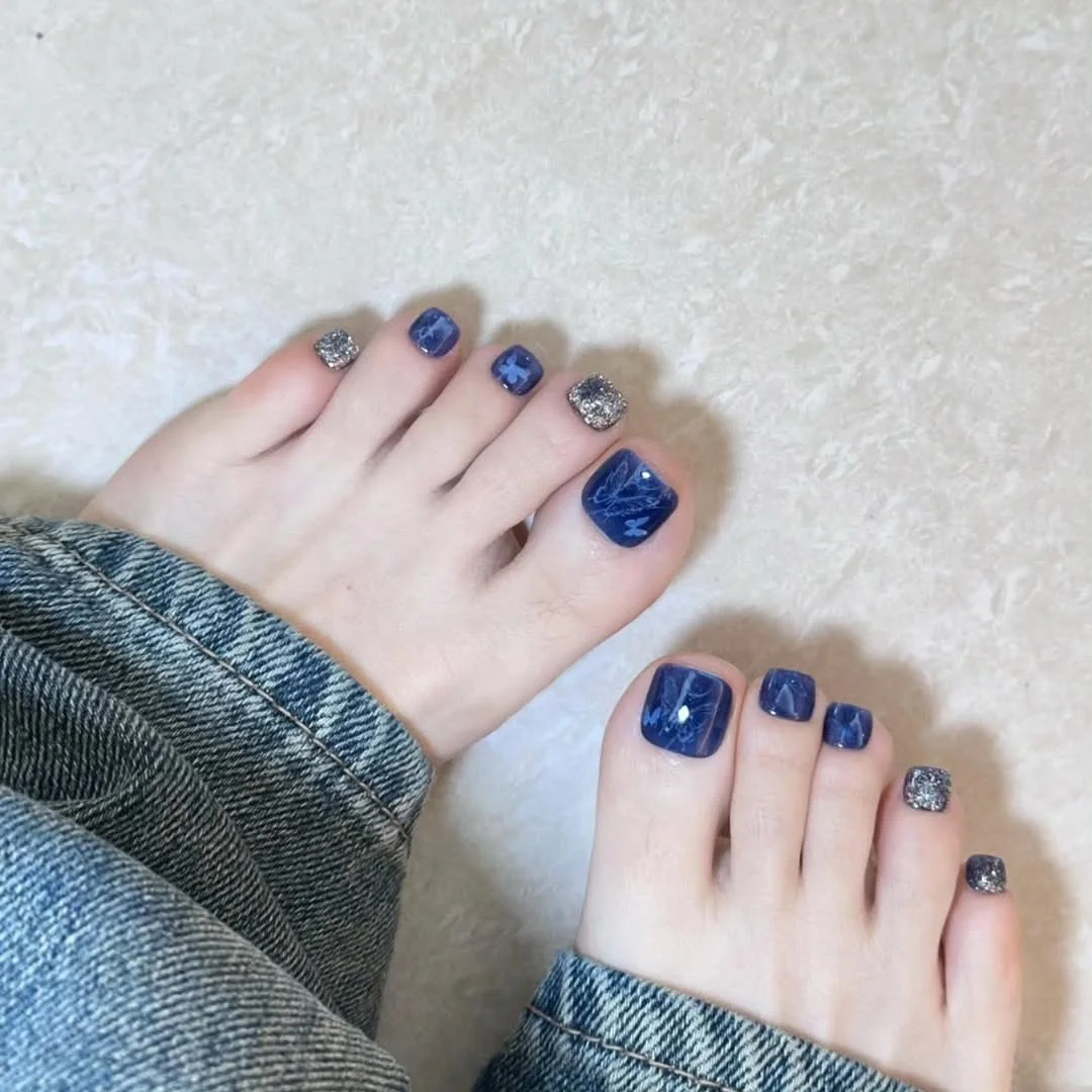 June pedicure ideas 2026 + Deep Navy Pedicure With Silver Glitter Accents