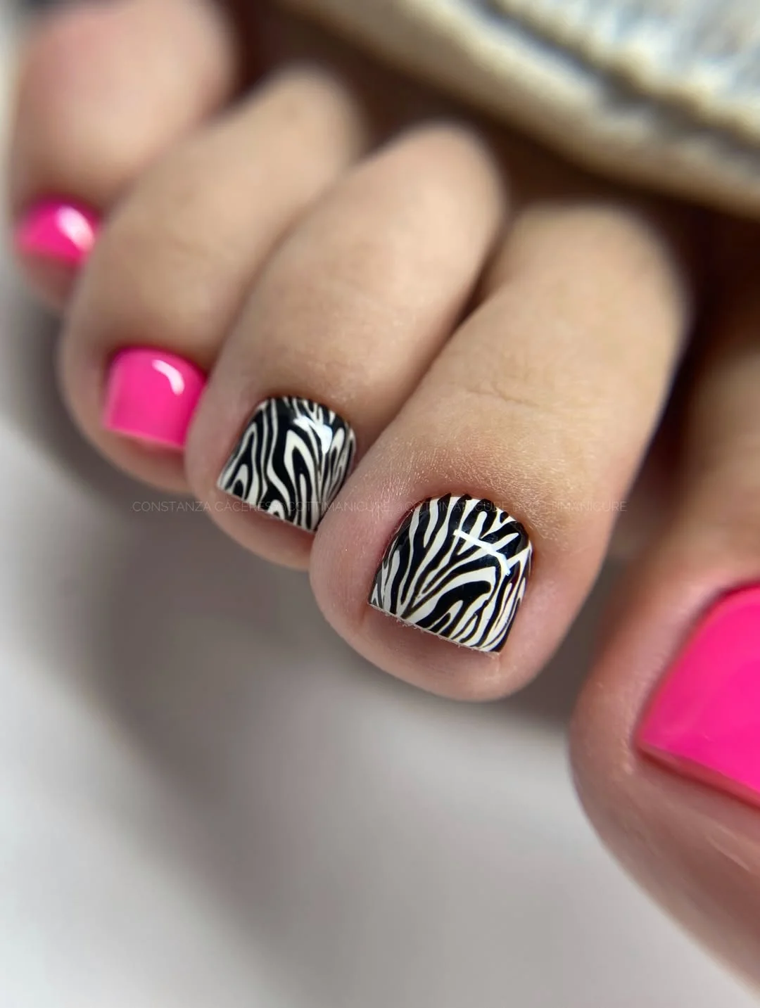 June pedicure ideas 2026 + Hot Pink Pedicure With Zebra Accent Nails
