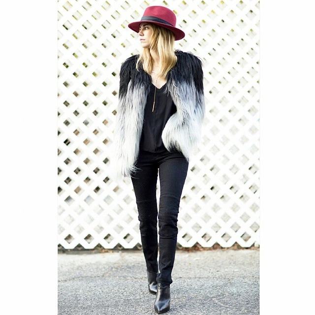 nice fall outfits 2026 Black-on-Black with a Statement Fur Vest and Burgundy Hat