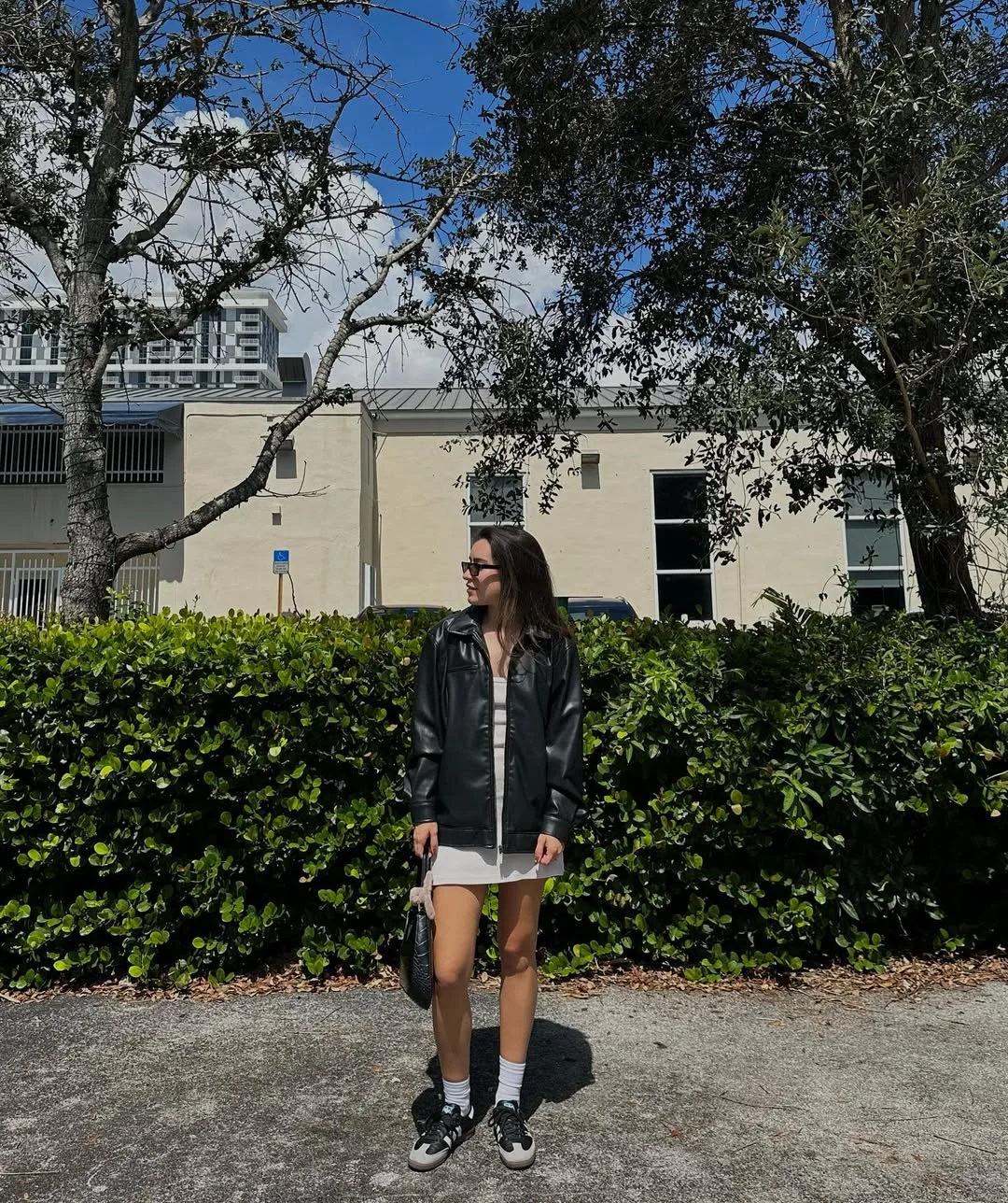 simpl fall outfits 2026 Black Leather Jacket Over a White Mini Dress