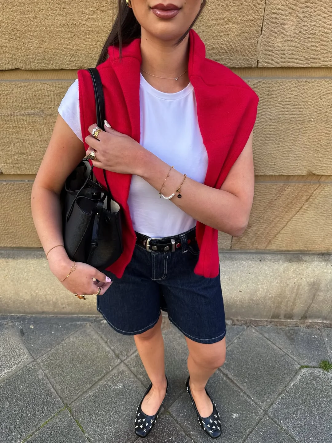 Summer to fall outfits 2026 Red Sweater Shoulder Layer With Dark Denim Shorts