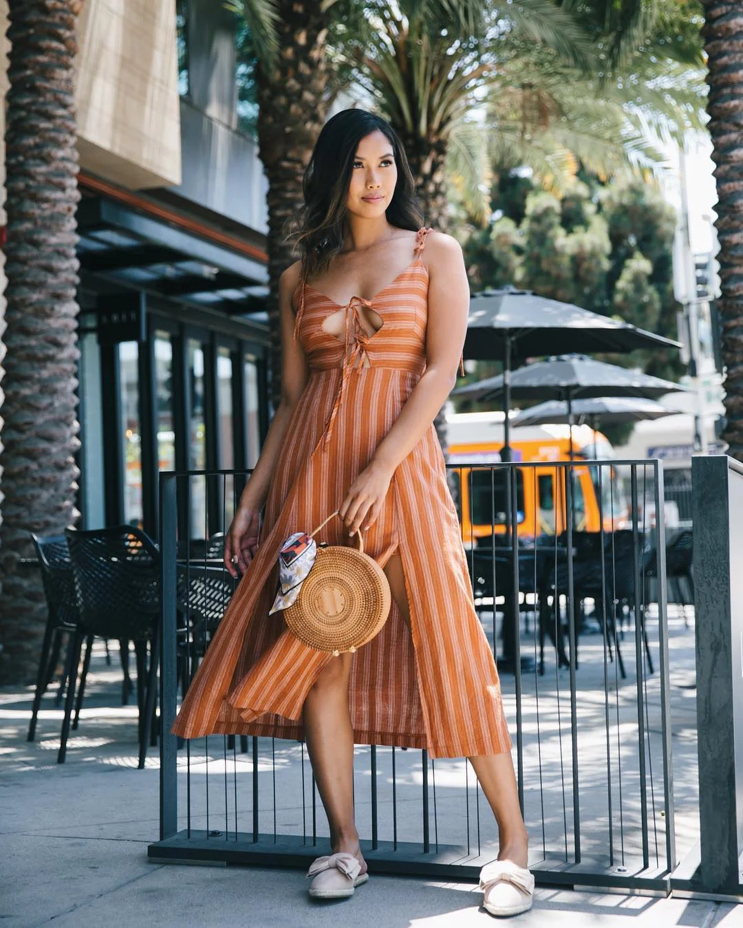 Summer to fall outfits 2026 Rust Striped Midi Dress With a Straw Bag