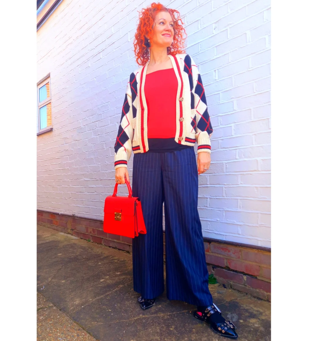 what to wear in fall 2026 over 50 Red Knit, Argyle Cardigan, and Pinstripe Trousers