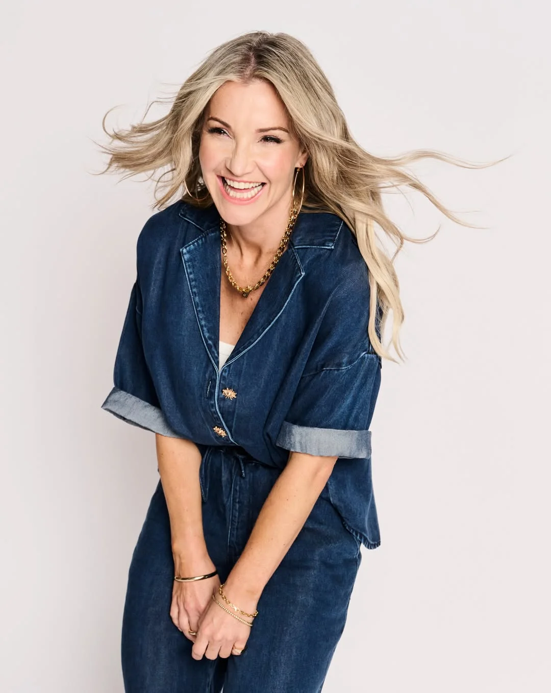 what to wear in fall 2026 over 50 Deep Denim Wrap Jumpsuit With Gold Jewelry