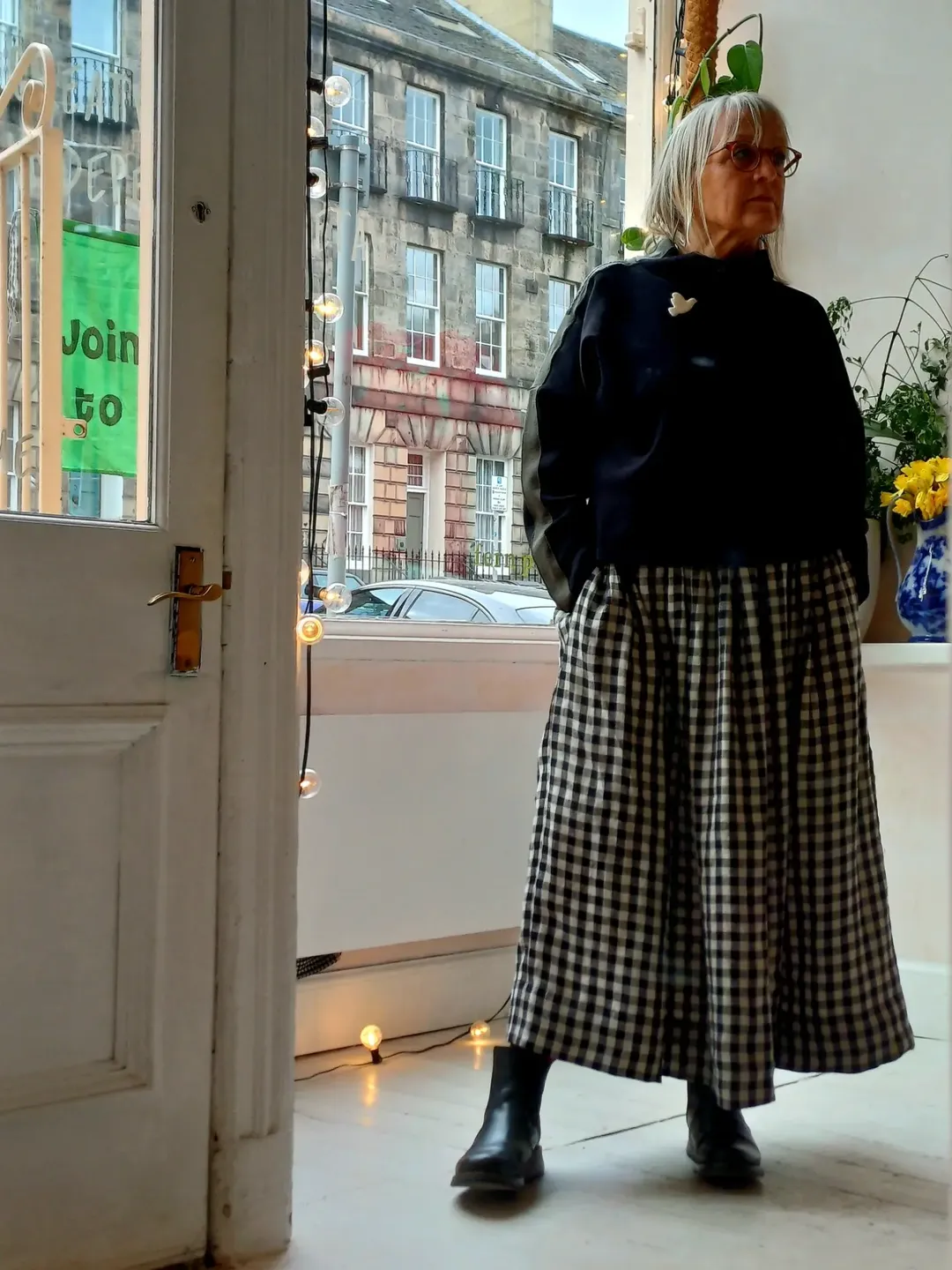 what to wear in fall 2026 over 50 Black Sweater With Gingham Wide-Leg Bottoms
