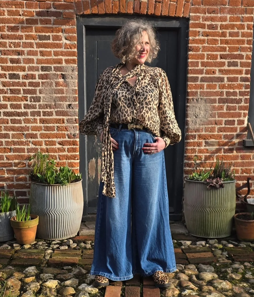 what to wear in fall 2026 over 50 Leopard Blouse With Wide-Leg Denim