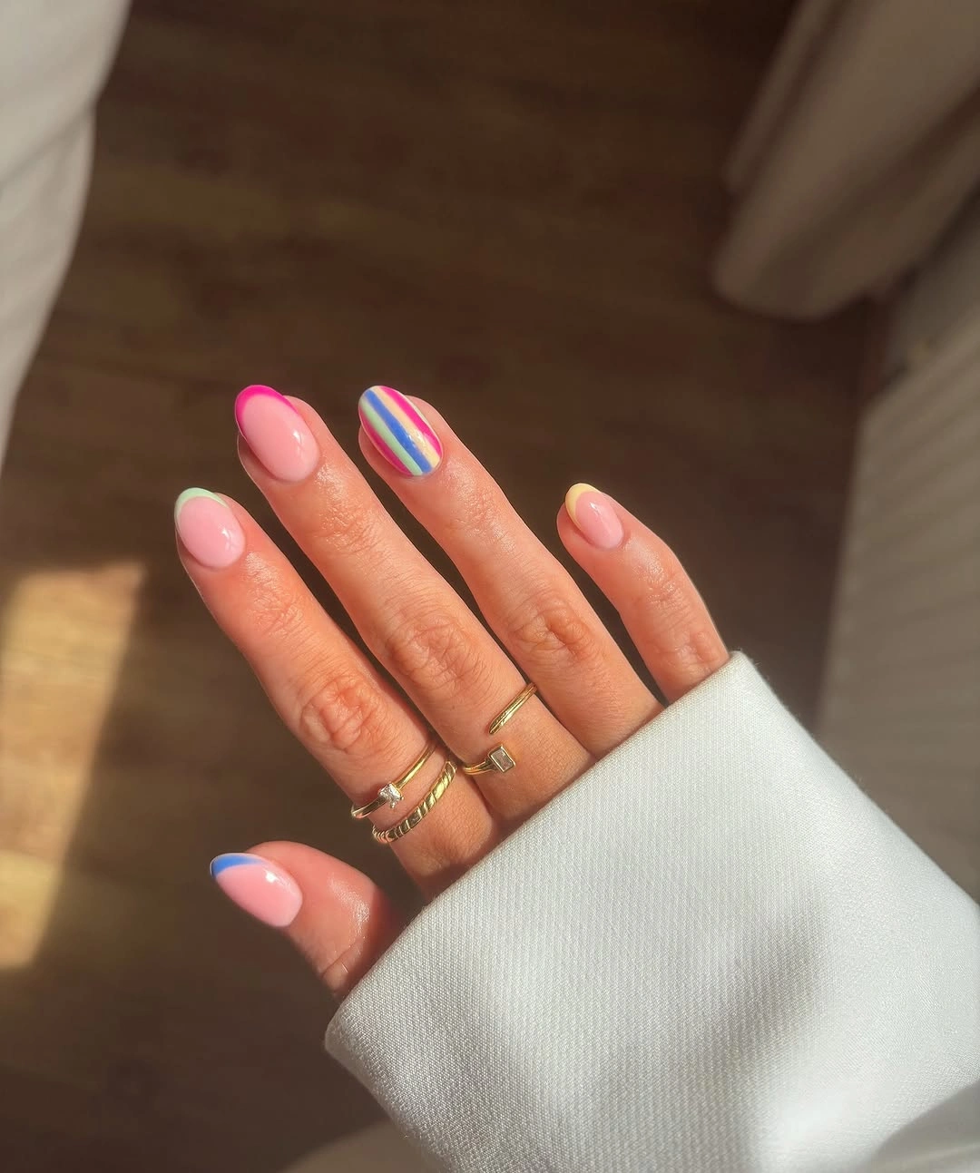 august nails color 2026 + Pastel French Tips With a Rainbow Accent