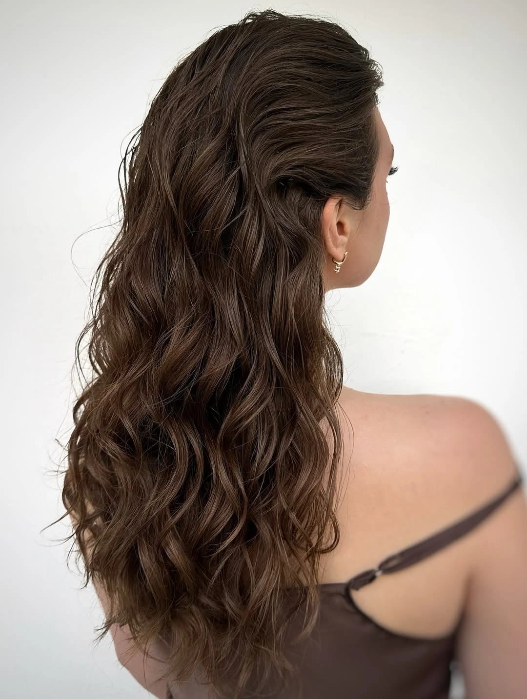 body waves hairstyle Relaxed Chocolate Waves With a Pinned-Back Front