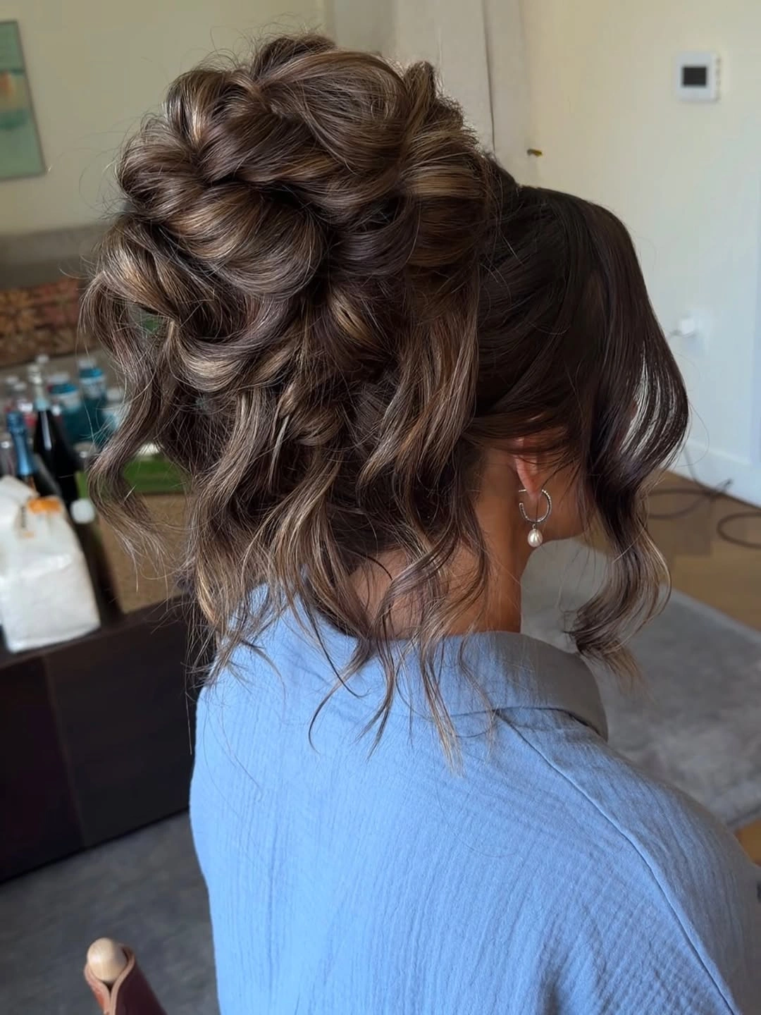 bridesmaid hairstyling Textured Brunette Bun With Lived-In Curls