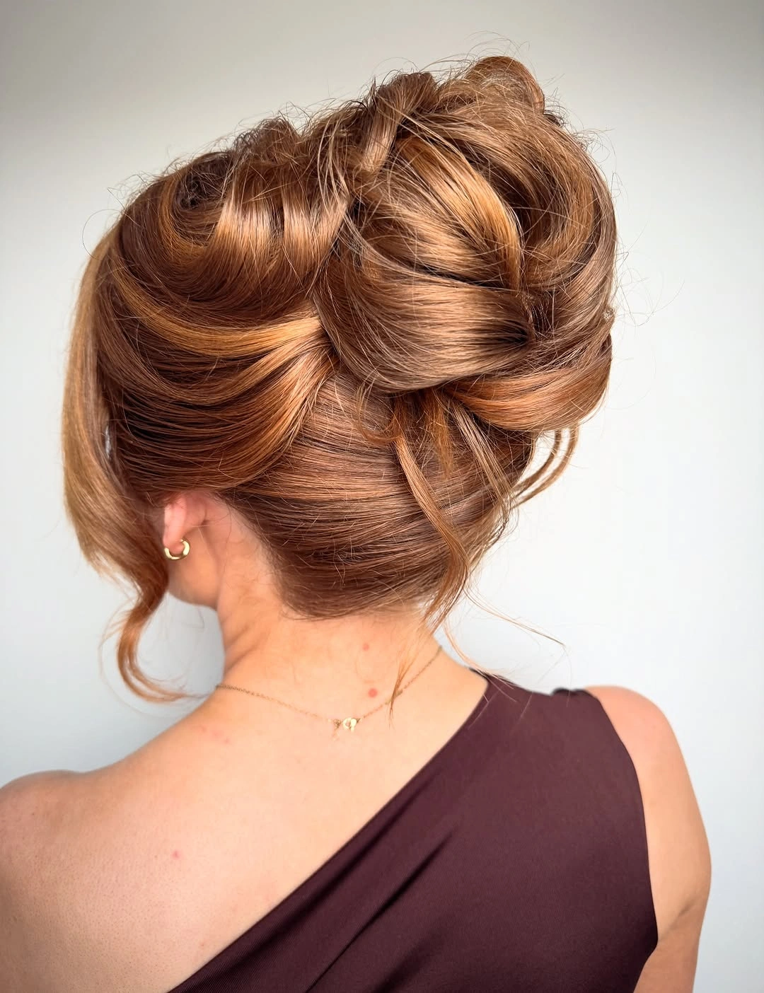 bridesmaid hairstyling Warm Auburn Updo With Sculptural Volume