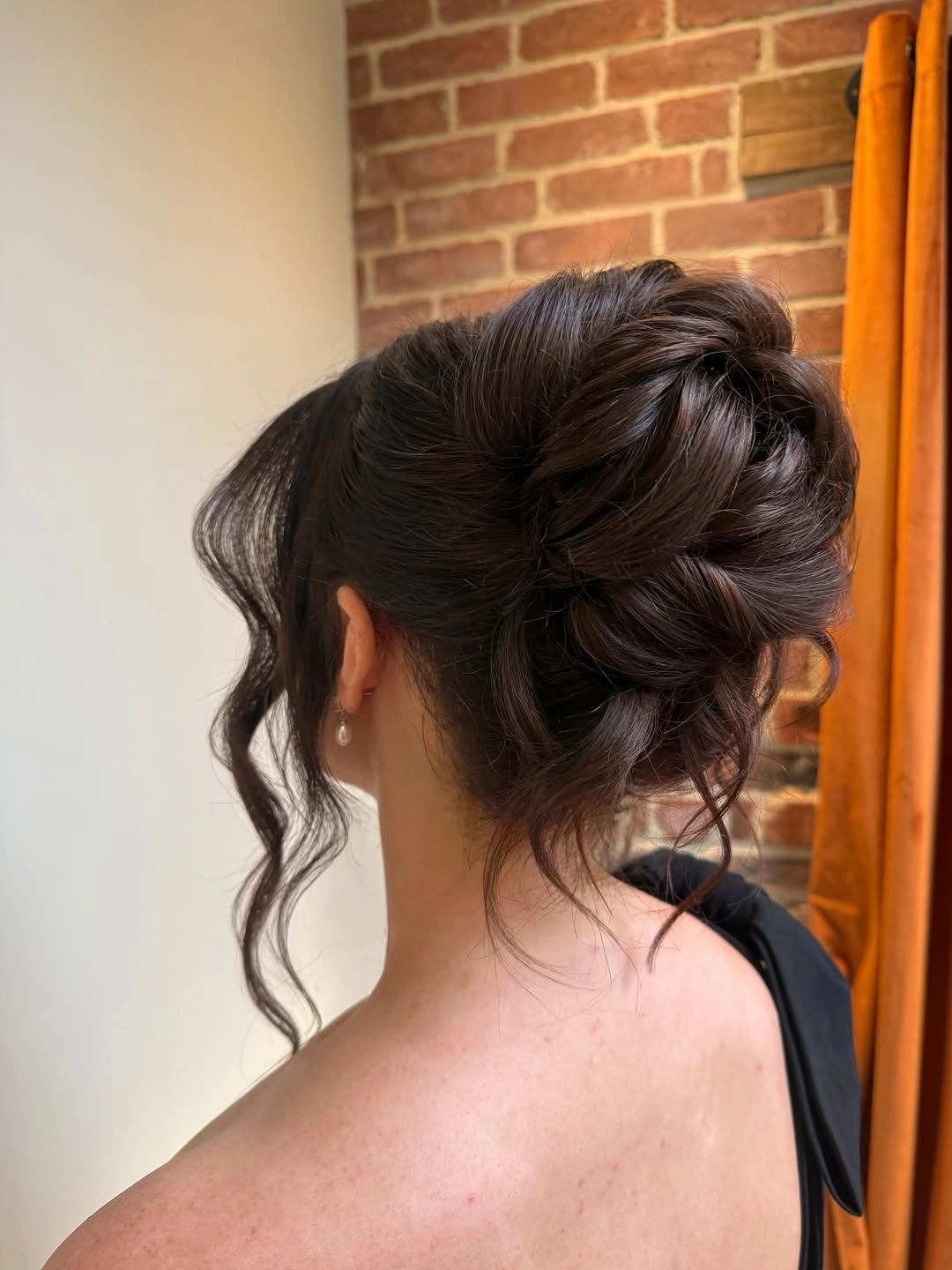 bridesmaid hairstyling Dark Romantic Updo With Wispy Movement
