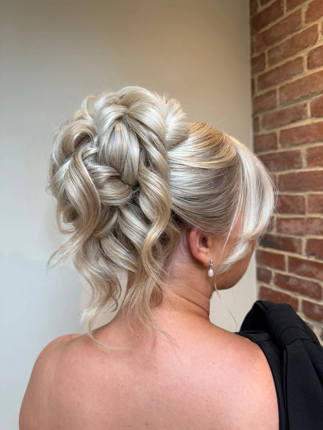 bridesmaid hairstyling Pearl-Blonde Updo With Loose Braided Texture