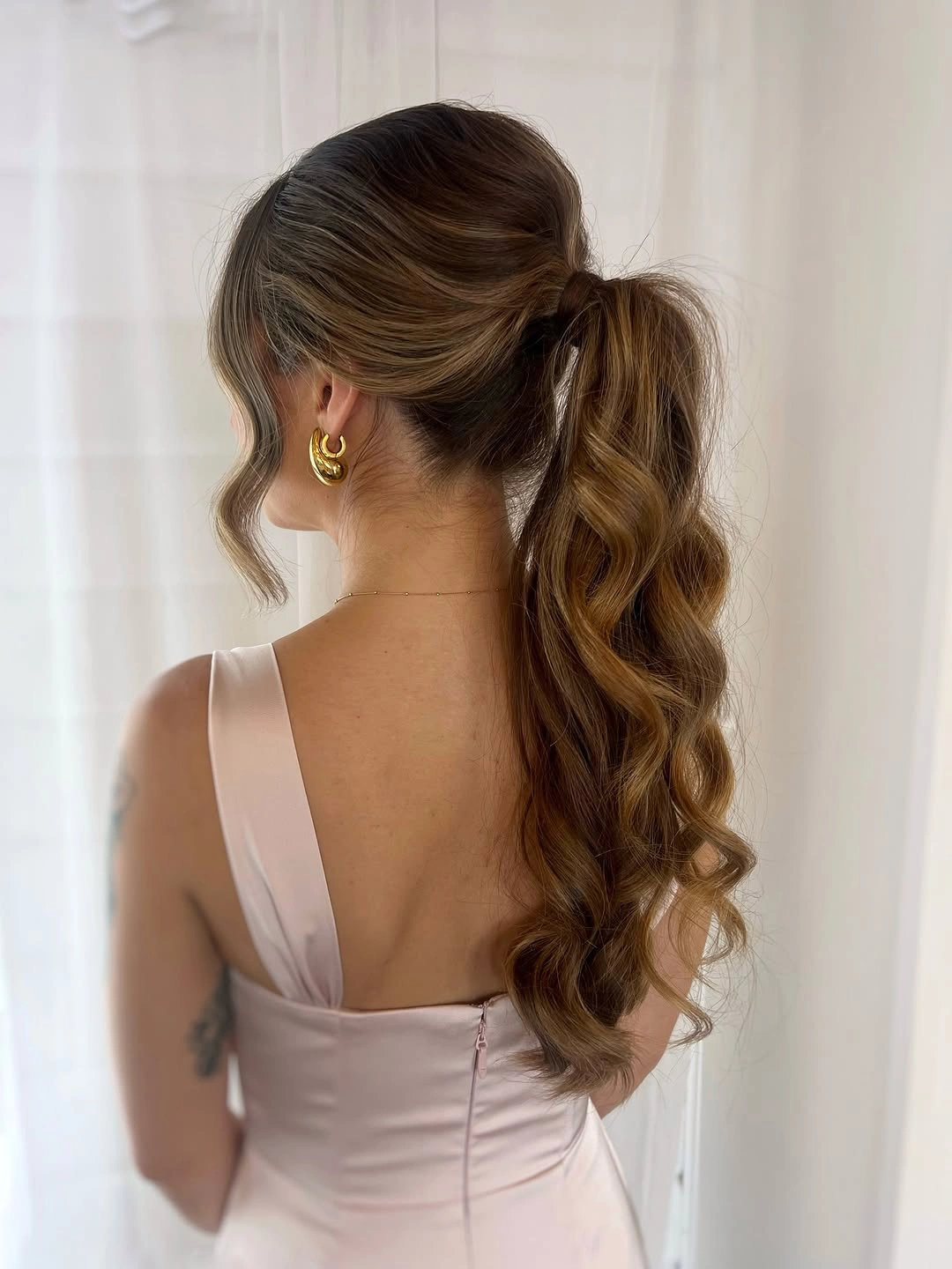 bridesmaid hairstyling Clean Ponytail With Polished Waves