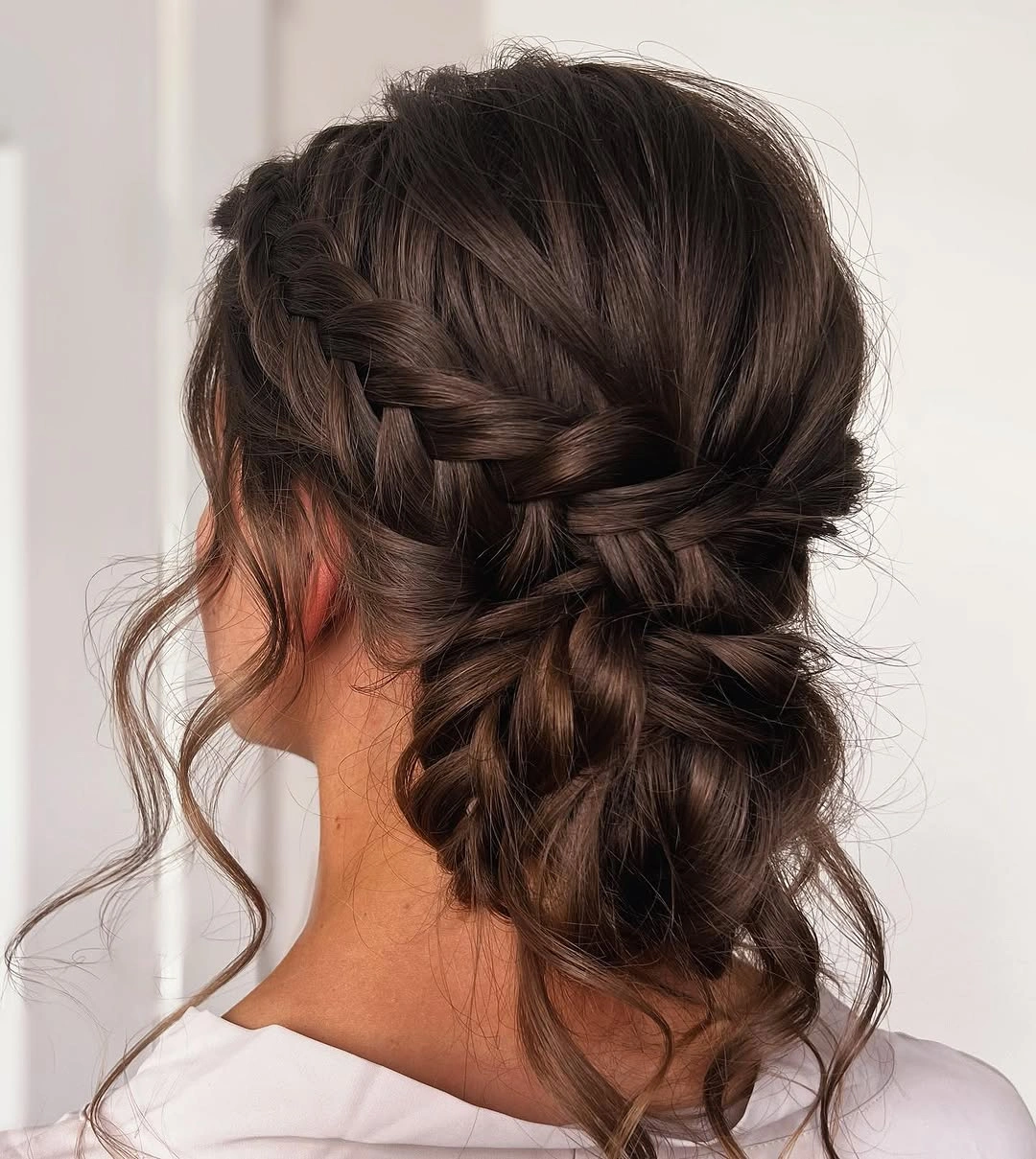 bridesmaid hairstyling Braided Low Bun With Loose Tendrils