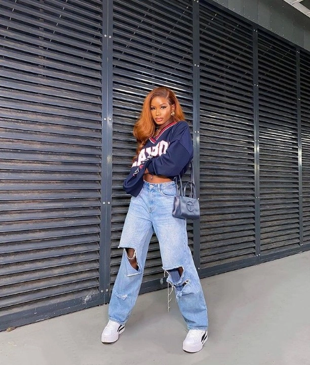 fall classy outfits women 2026 + Ripped Denim and a Cropped Varsity Layer