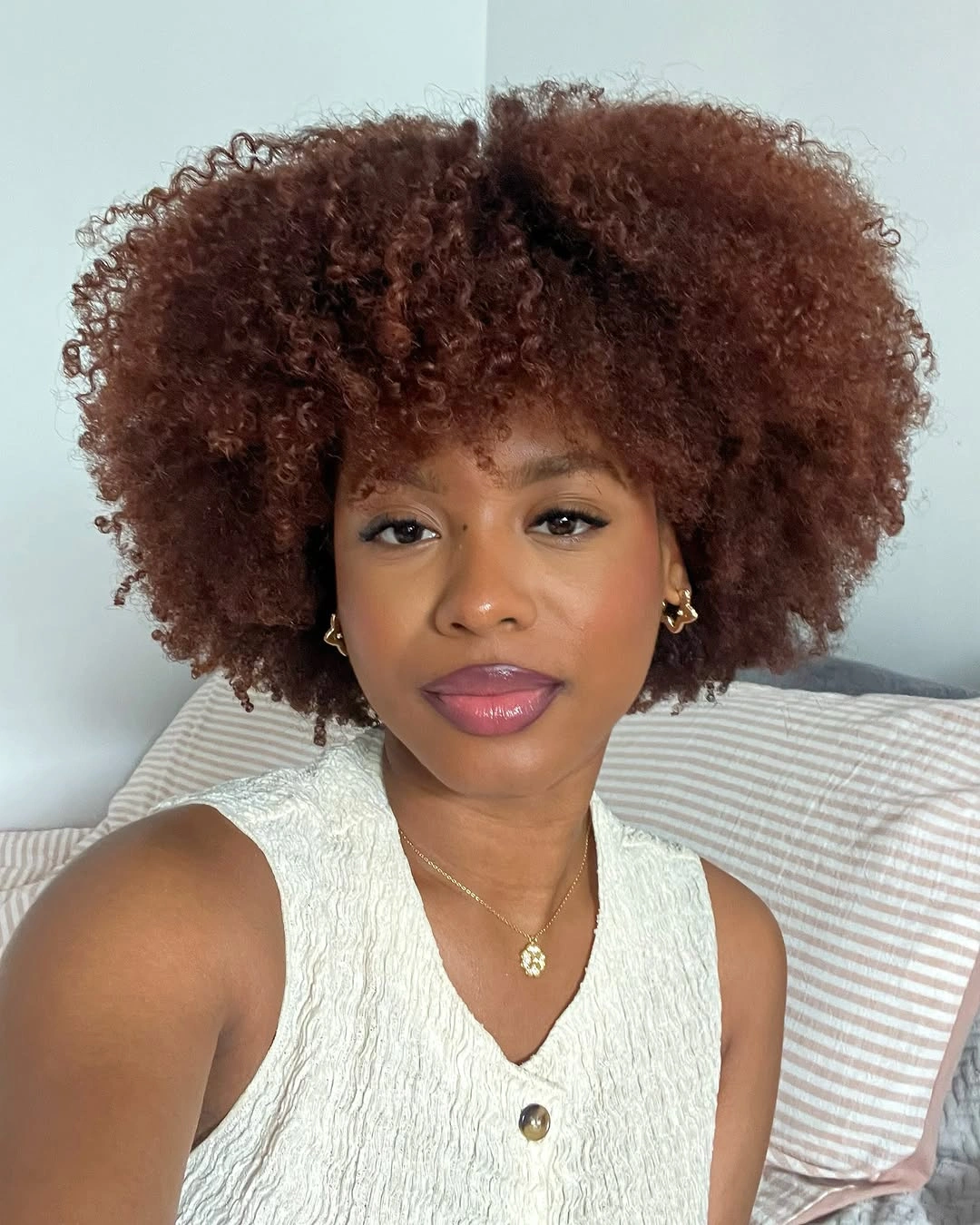 fall hair colors for black women 2026 Auburn Natural Curls With Soft Cream Styling